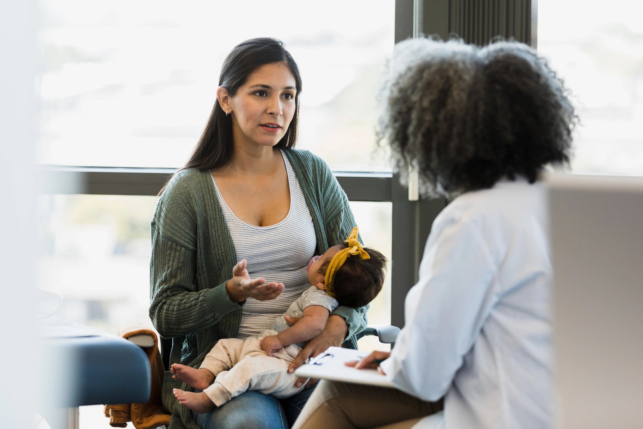 Parent and clinician discussing a child’s needs during a visit
