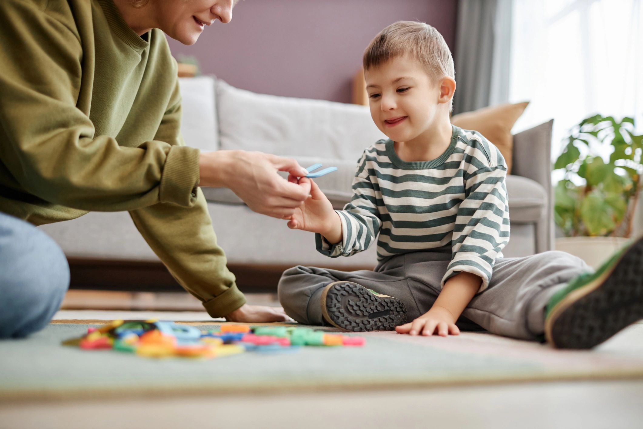 Child engaged in a learning activity on the floor at home