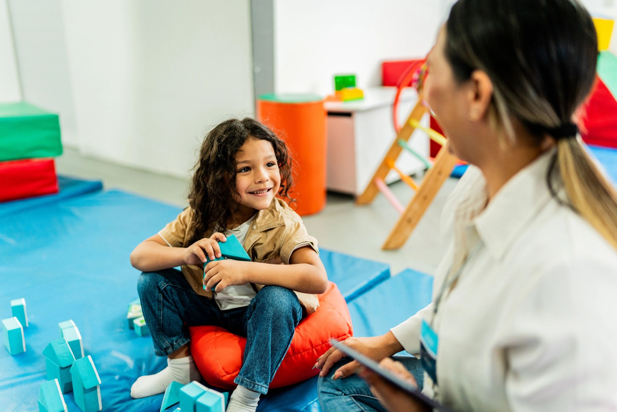 Child engaged in sensory-based play activities during therapy
