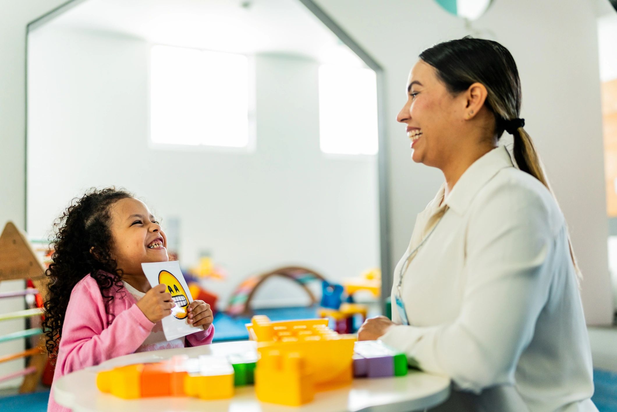Therapist engaging a child in a play-based activity