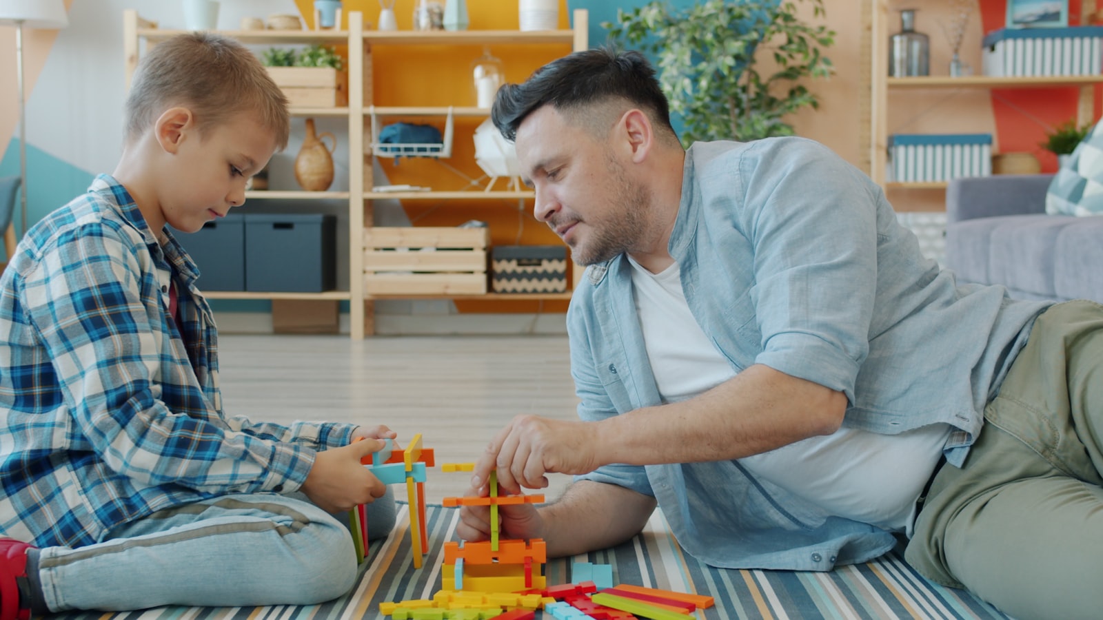 Pediatric occupational therapist and child building with colorful blocks during an in-home therapy session in Greater Houston