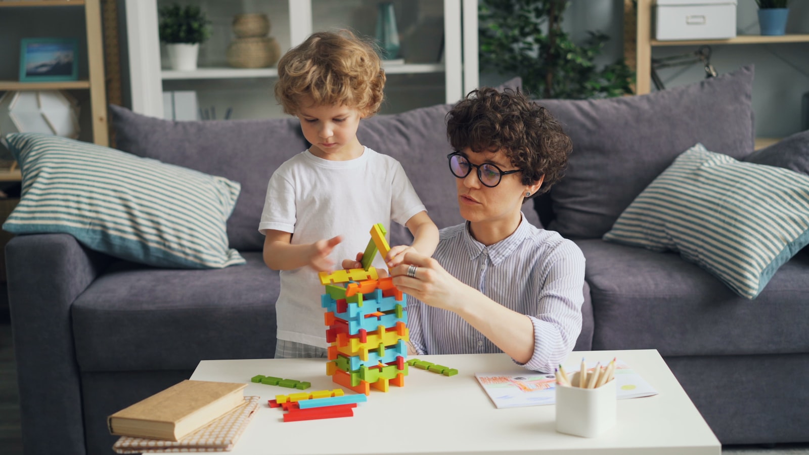 Child building fine motor skills with a construction toy